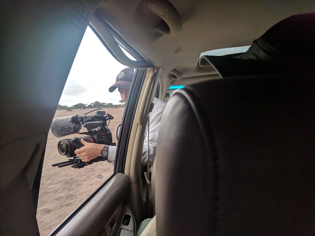 Camera crew filming pastoral community
